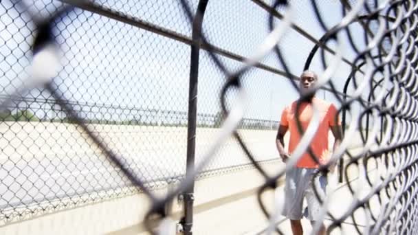 African American runner resting on bridge — Stock Video