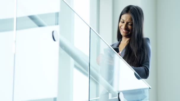 Businesswoman using wireless tablet in office building — Stock Video