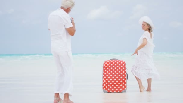 Pareja de ancianos tomando fotos en la playa — Vídeos de Stock