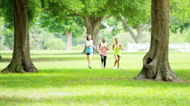 Multi ethnic girls running in park — Stock Video