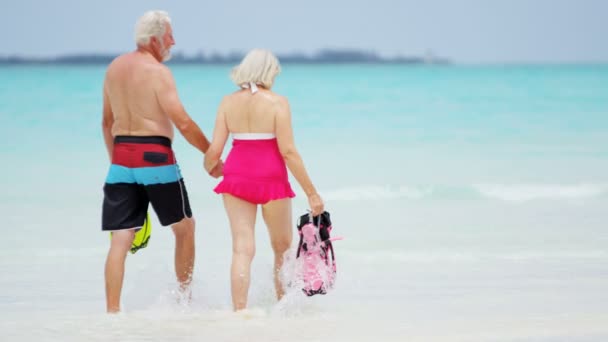 Senior pareja caucásica en traje de baño haciendo snorkel — Vídeo de stock