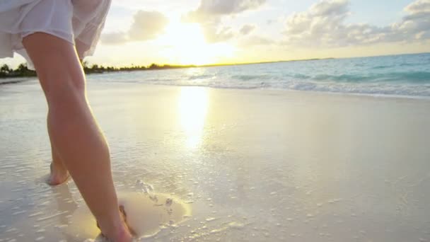 Ноги женщины, идущей босиком по пляжу — стоковое видео