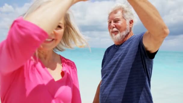 Casal sênior dançando em uma praia tropical — Vídeo de Stock