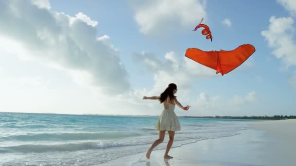 해변에 빨간색 연 노는 아시아 소녀 — 비디오