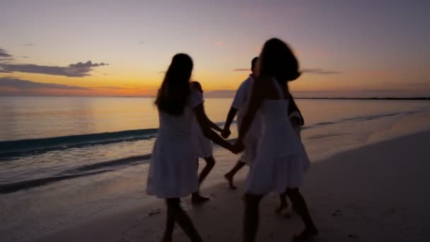 Família caucasiana desfrutando de férias na praia ao pôr do sol — Vídeo de Stock