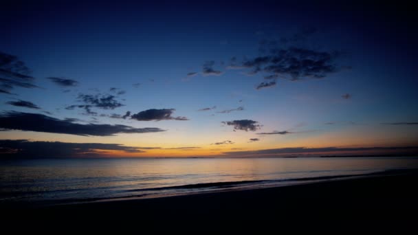 Ocean waves washing sandy beach at sunset — Stock Video