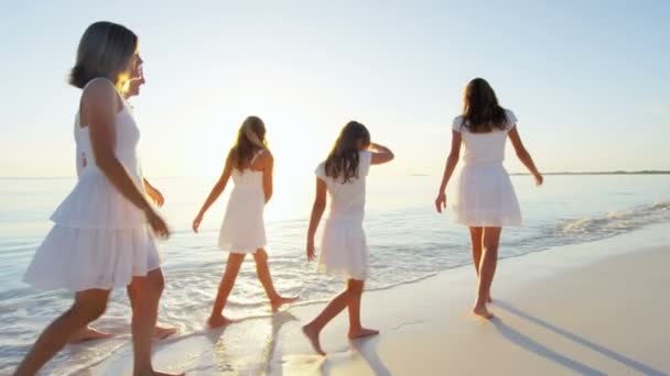 Familia caucásica disfrutando de vacaciones en la playa al atardecer — Vídeo de stock