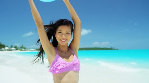 Chica china jugando con pelota de playa en la playa — Vídeo de stock