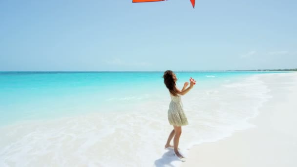 Chica asiática jugando con cometa roja en la playa — Vídeos de Stock