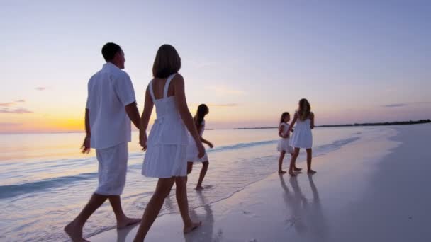 Caucasian family enjoying beach vacation at sunset — Stock Video