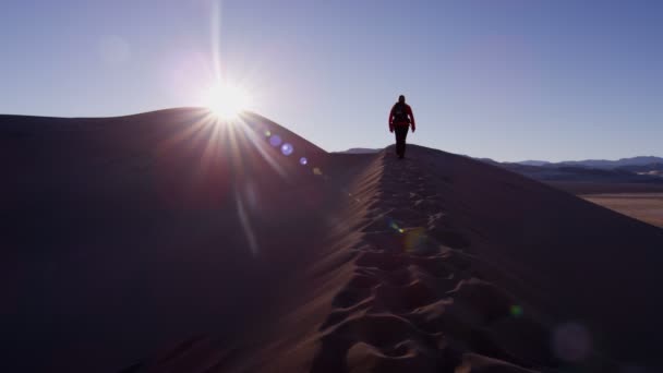 Woman explorer walking through sand dunes — Stock Video