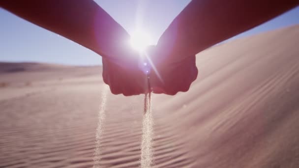 Femme jetant du sable à travers les doigts — Video