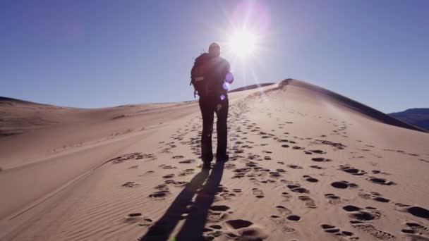 Woman explorer walking through sand dunes — Stock Video