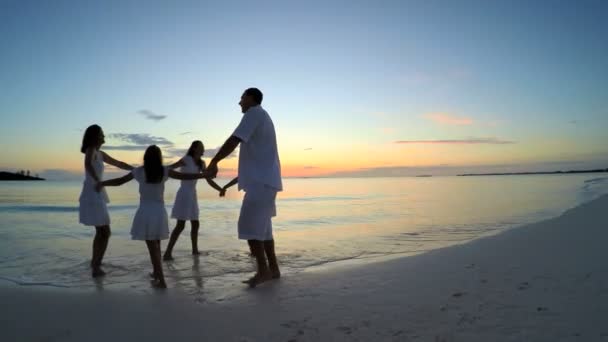 Família caucasiana desfrutando de férias na praia ao pôr do sol — Vídeo de Stock