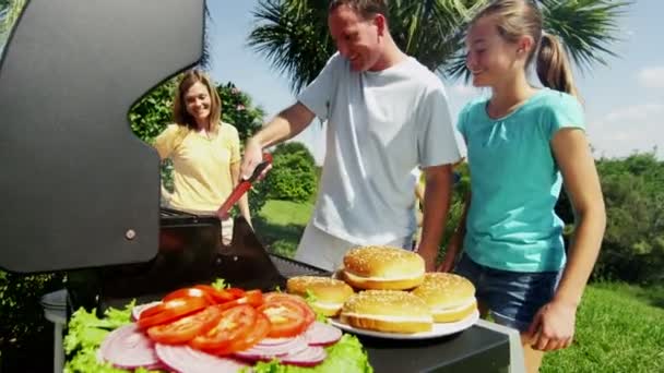 Pais com filhas grelhar carne churrasco — Vídeo de Stock