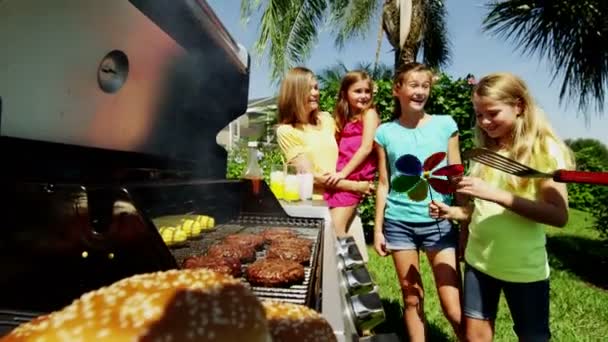 Parents with daughters grilling barbecue meat — Stock Video