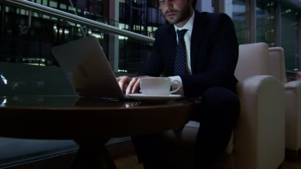 Businessman working with laptop and smart phone at night — Stock Video