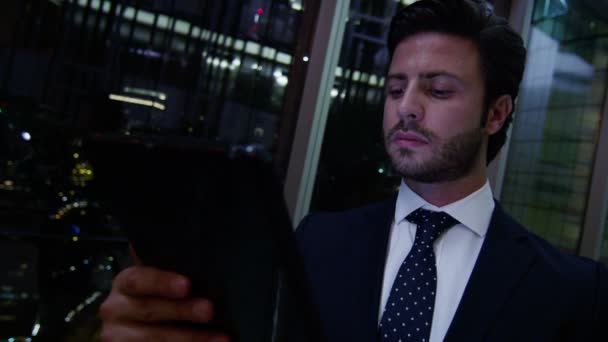 Arabic businessman using digital tablet at night — Stock Video