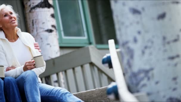 Senior couple drinking coffee on the porch — Stock Video