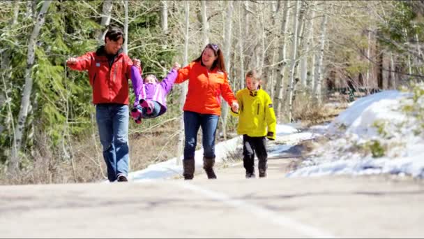 Семья с детьми, гуляющими в зимнем парке — стоковое видео