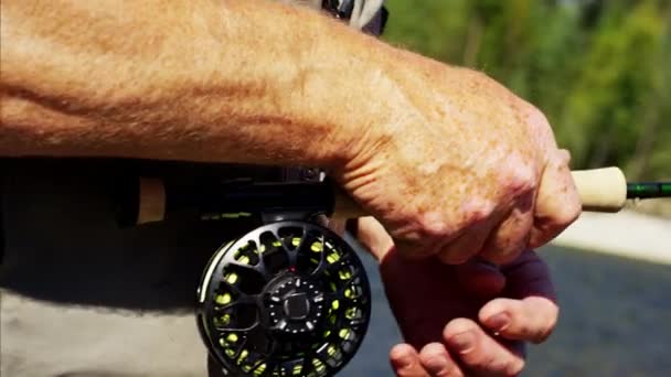 Fisherman using rod and reel casting line — Stock Video