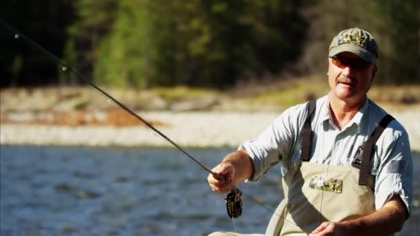 Fisherman using rod and reel casting line — Stock Video