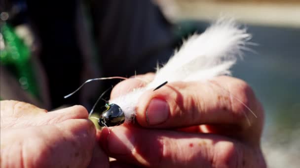 Fisherman preparing hand tied fly — Stock Video