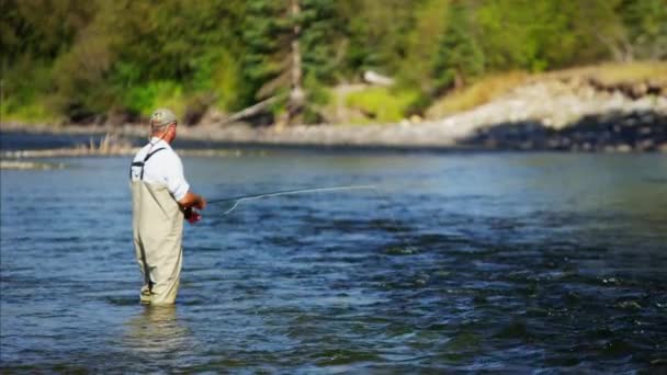 Fisherman using rod and reel casting line — Stock Video