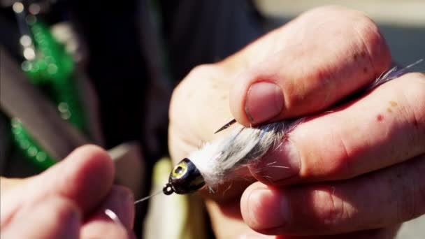 Fisherman hand tying dry fly — Stock Video