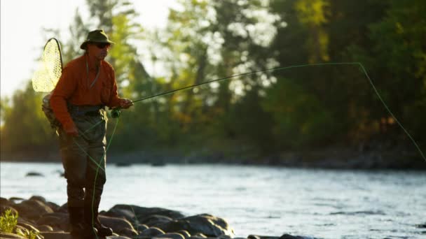 Fisherman using rod and reel casting line — Stock Video