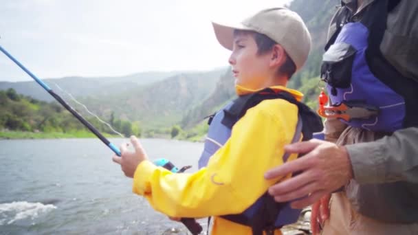 Boy learning fishing with father — Stock Video
