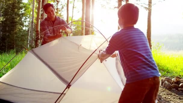 Parent and boy erecting tent — Stock Video