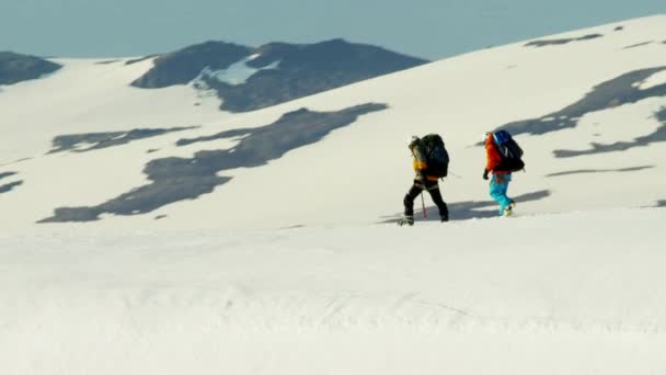 Альпіністи перетинають сніговий покритий гірський хребет — стокове відео