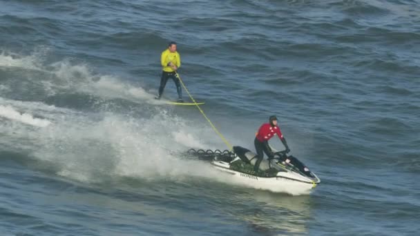 Aerial jet ski towing surfer on surface California — Stock Video