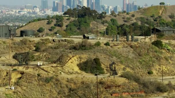 Aerial view Inglewood oil field LA city skyline — Stock Video