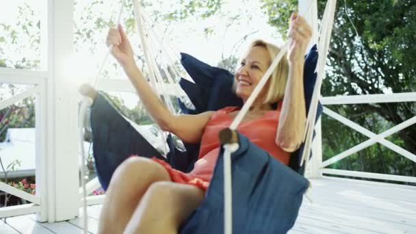 Retired woman relaxing in hammock on terrace Bahamas — Stock Video