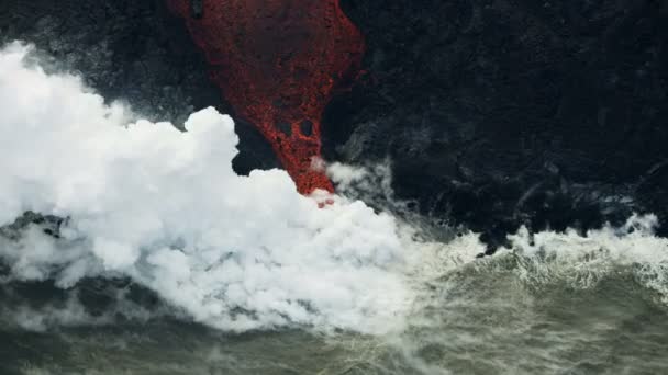 Aerial river of active volcanic lava flowing seaward — Stock Video