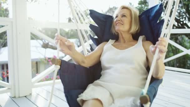 Retired woman relaxing in hammock on terrace Bahamas — Stock Video