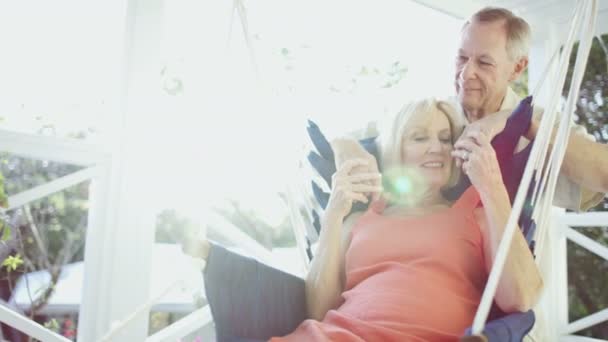 Senior couple relaxing in hammock on terrace Bahamas — Stock Video