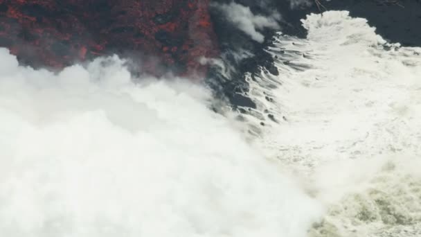 Aerial view river of volcanic lava flowing seaward — Stock Video