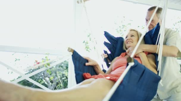 Male and female seniors in hammock outdoor Bahamas — Stock Video