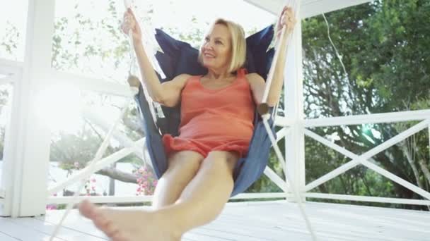 Senior Caucasian female relaxing in hammock outdoor Bahamas — Stock Video