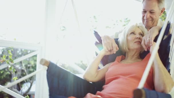 Male and female seniors resting in hammock Bahamas — Stock Video