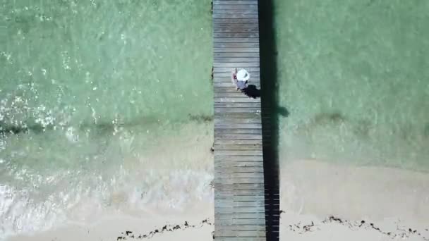 Atractiva hembra con sombrero blanco en embarcadero Bahamas — Vídeos de Stock