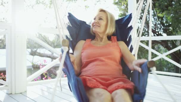 Senior Caucasian female relaxing in hammock outdoor Bahamas — Stock Video