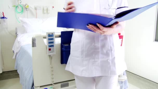 Female nursing aide in white uniform — Stock Video