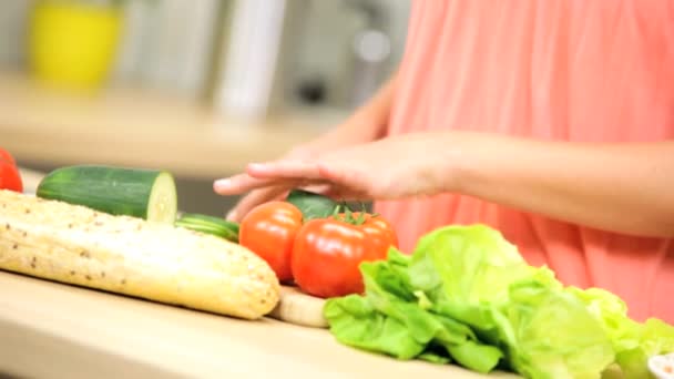 Salad vegetables being sliced by young girl — Stock Video