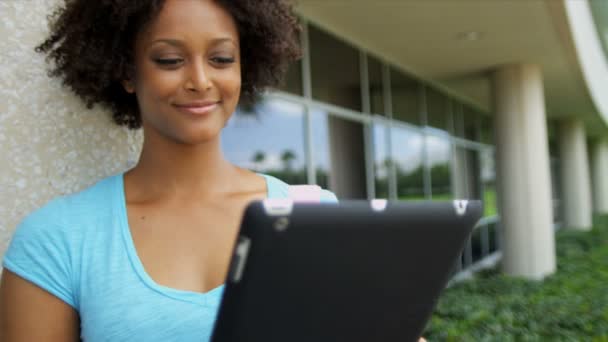 Female student holding wireless tablet — Stock Video