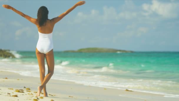 Молодая женщина наслаждается на роскошном пляже — стоковое видео