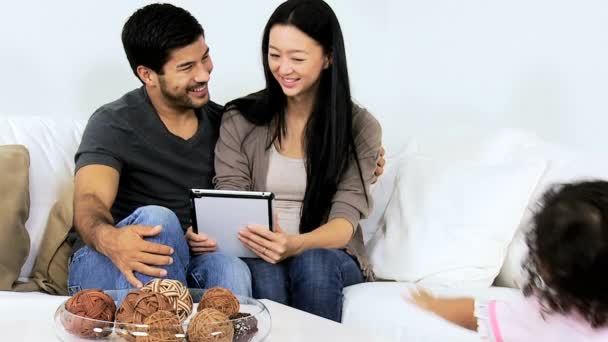 Parents with daughter using tablet — Stock Video